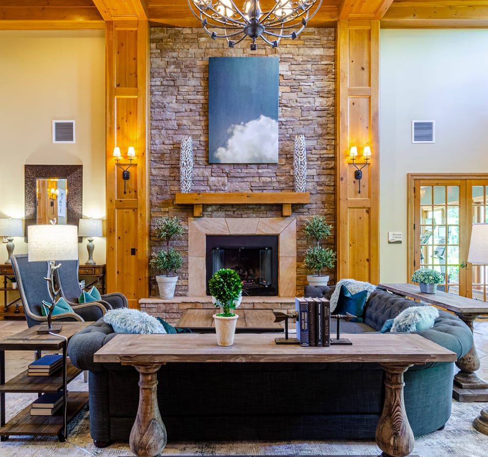Rustic apartment clubhouse with wood paneling and high ceilings