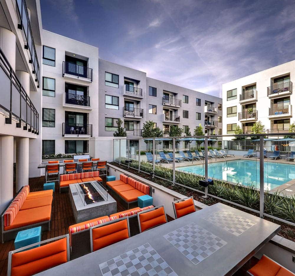 Orange and blue outdoor lounge with firepits and chess tables