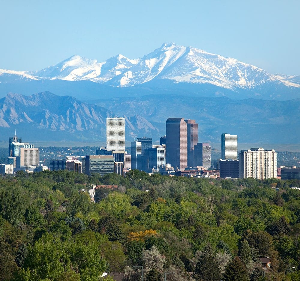 City skyline against a mountain backdrop