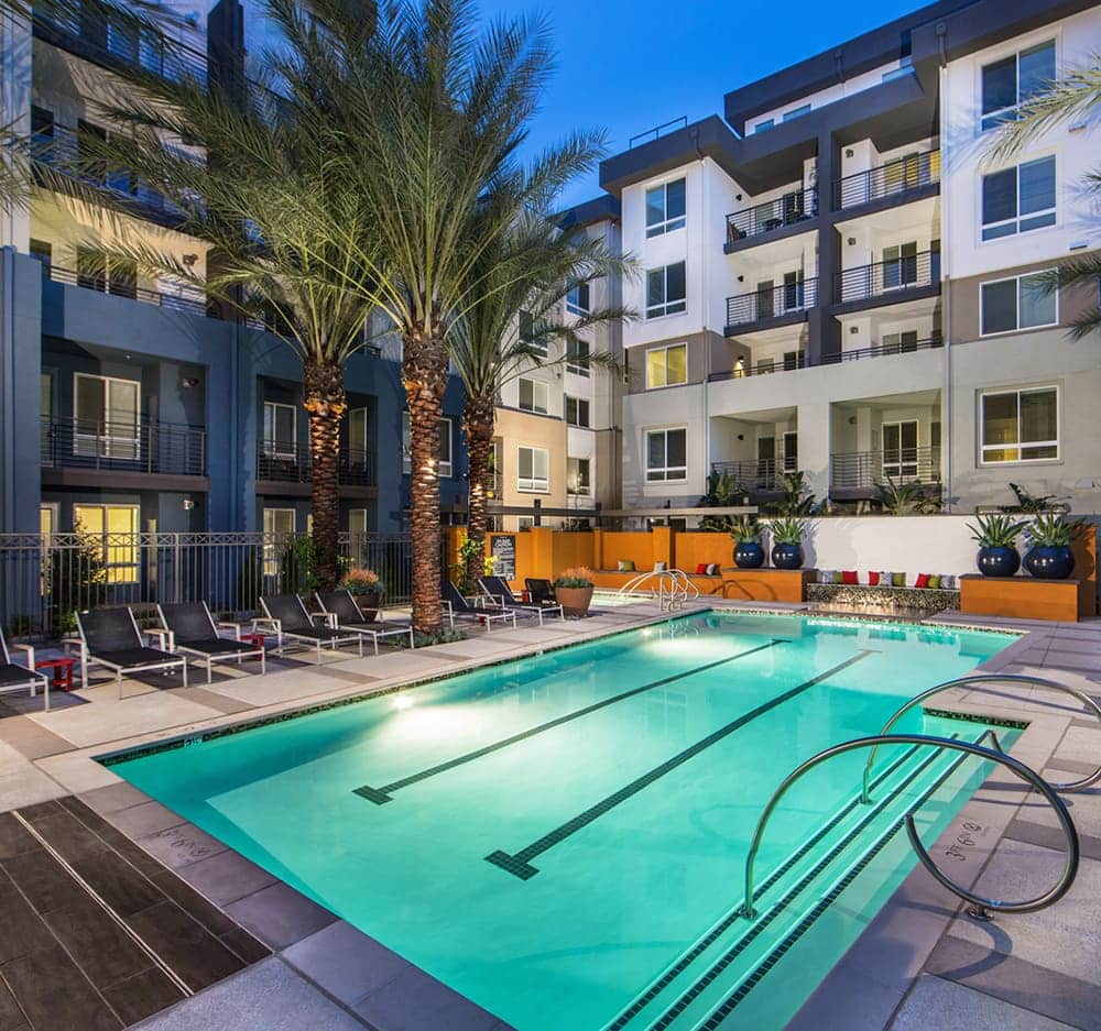 Tropical style pool surrounded by apartment buildings
