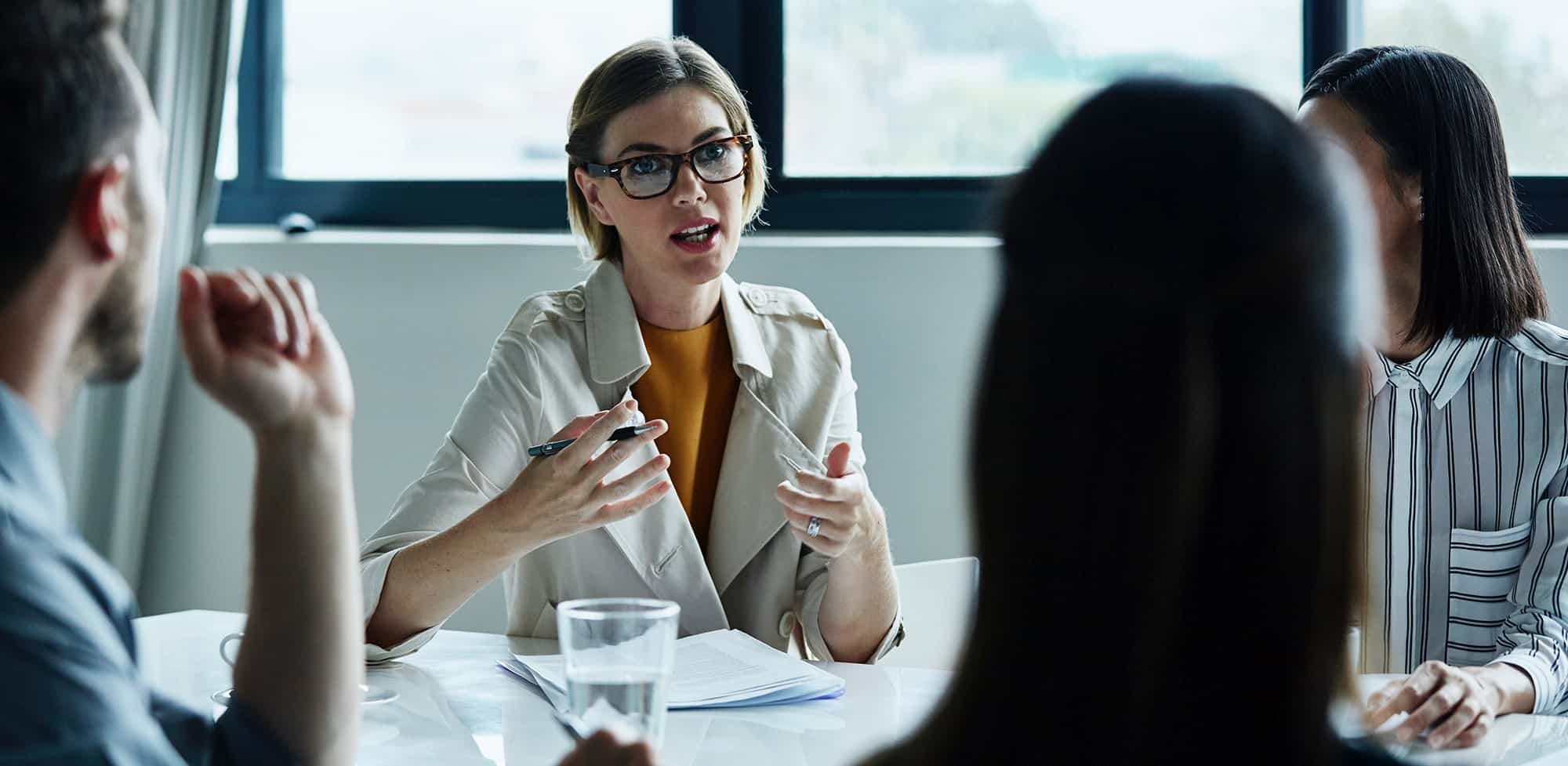 A businesswoman talks to her colleagues during a meeting